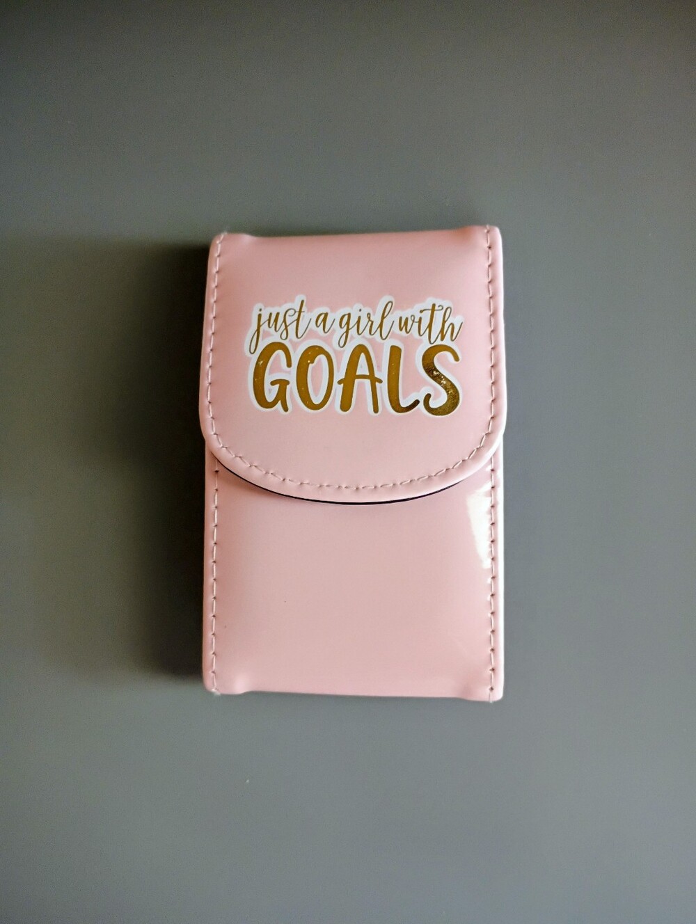 Pink manicure set with gold text reading 'just a girl with GOALS'